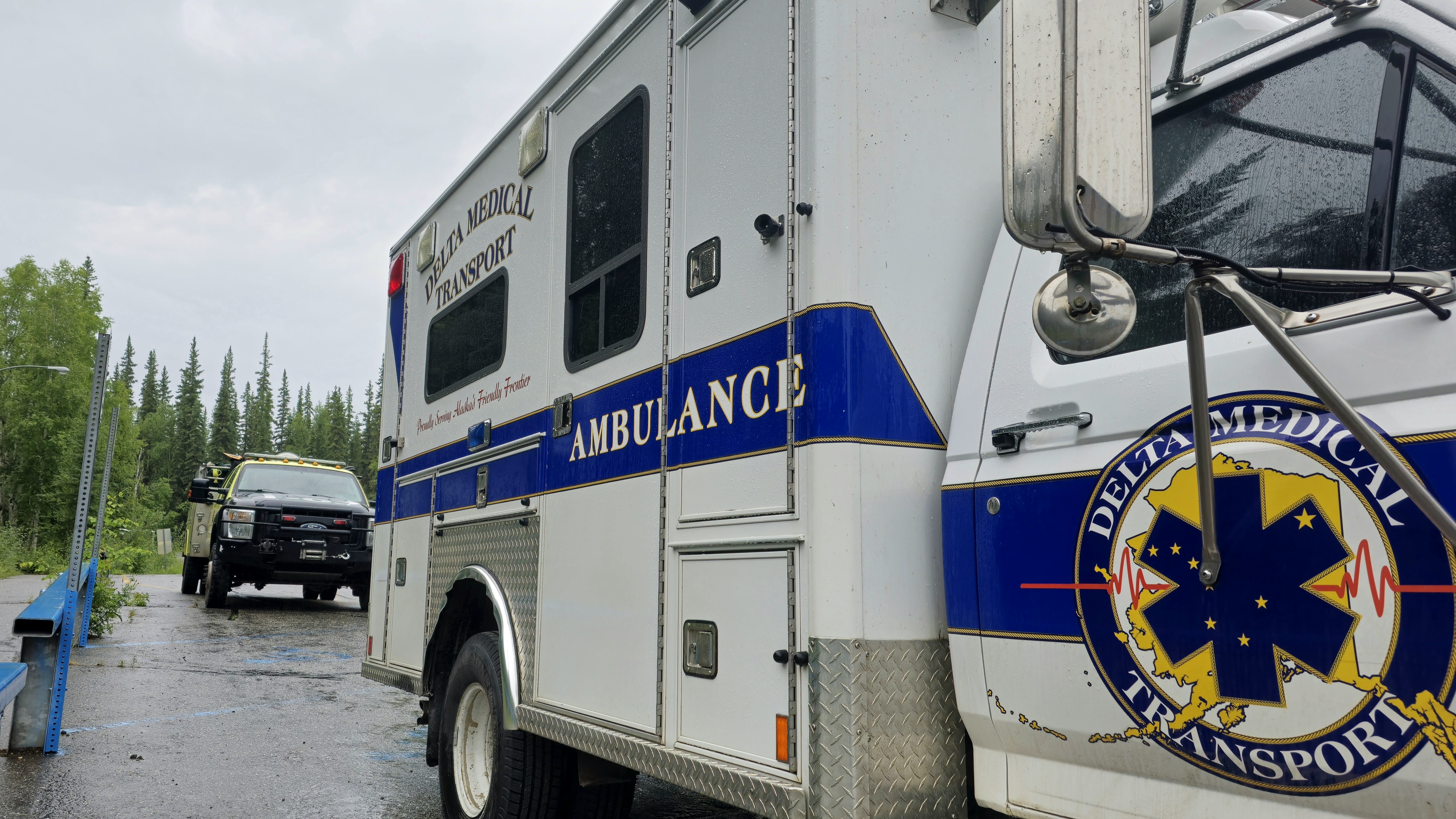 Ambulance and fire engine parked along road