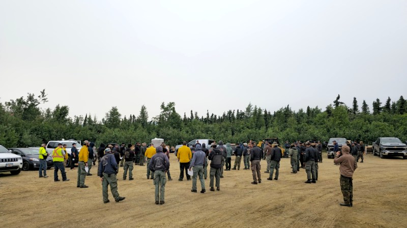 Group of firefighters gathered outside for a morning briefing.