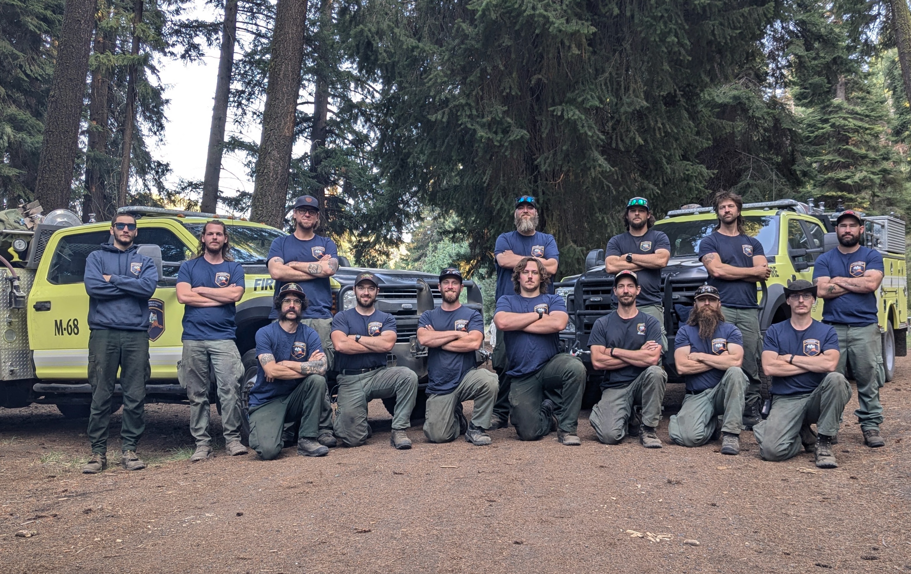 Photo of Alaskan firefighters in front of wildland firefighting engines in Oregon