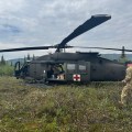 An Alaska National Guard crew member walks towards a UH60 Blackhawk helicopter.
