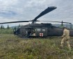 An Alaska National Guard crew member walks towards a UH60 Blackhawk helicopter.
