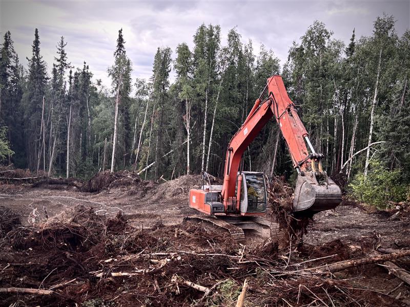 An excavator digs through dozer berms searching for hot spots. 📸 Nikos Kilcher/DOF, July 27 2025