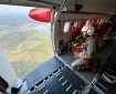 Smokejumper surveys the Alaska landscape south of Fort Yukon from the open door of the plane.