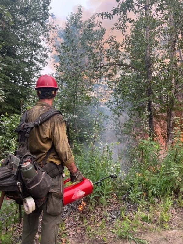 Image of a firefighter holding a drip torch