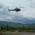 A Eurocopter A-Star helicopter picks up an sling load from the Gunsight Helibase to transport to fire crews working on the Nelchina Glacier Fire.