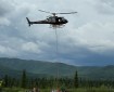 A Eurocopter A-Star helicopter picks up an sling load from the Gunsight Helibase to transport to fire crews working on the Nelchina Glacier Fire.