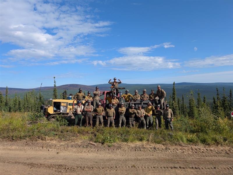 Fire personnel working on the Aggie Creek Fire posing with the Nodwell Crew machinery. July 26,2025