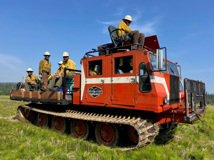 The Aravaipa crew of firefighters ride to the fireline on a Nodwell.