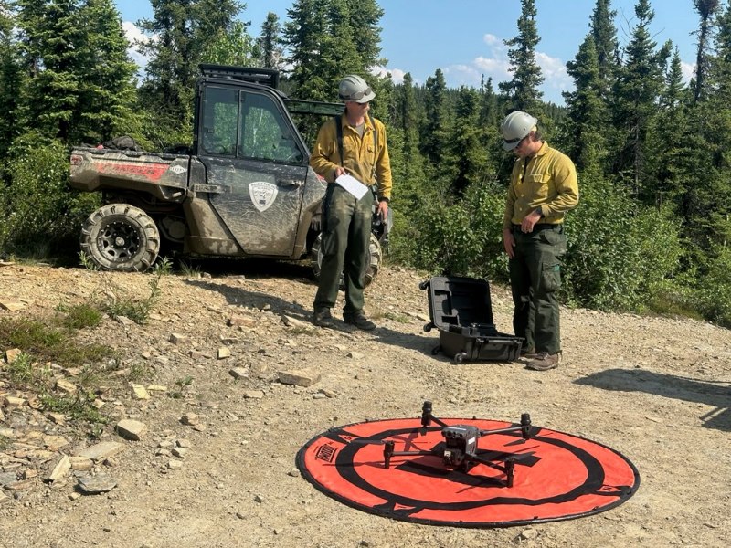 Two firefighters operate and an Infrared equipped drone, to search for hot-spots on the Bear Creek Fire's perimeter. 