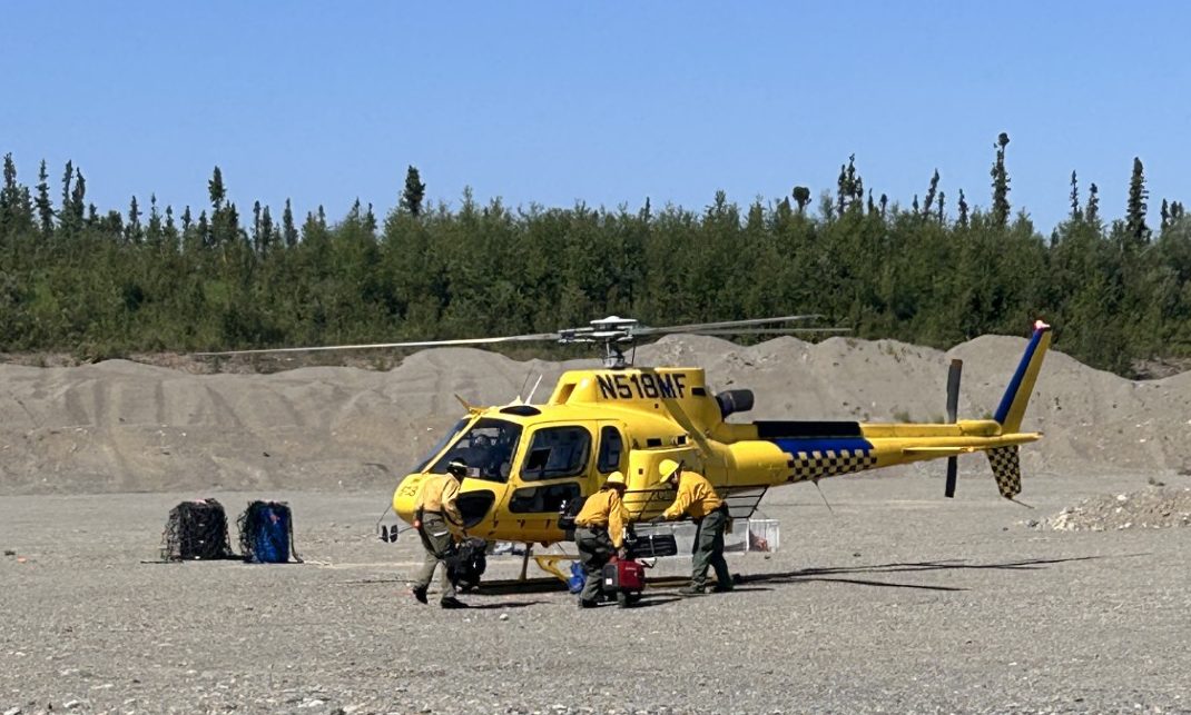 Image of firefighters loading a helicopter