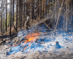 A firefighter completes a pile burn along the 7 Mile Lookout Fire.