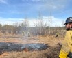 Creamers Field Echo Acres RX white Mountain Fire Crew holsing wet line and Logan Parsley, Fairbanks Area Tech supervising the fire behavior