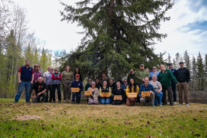 Division of Forestry & Fire Protection staff with Division of Mining, Lands and Water staff gather outside the Department of Natural Resources building in Fairbanks with the new memorial signs. 