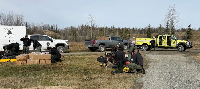 Wildland firefighters sort their equipment.