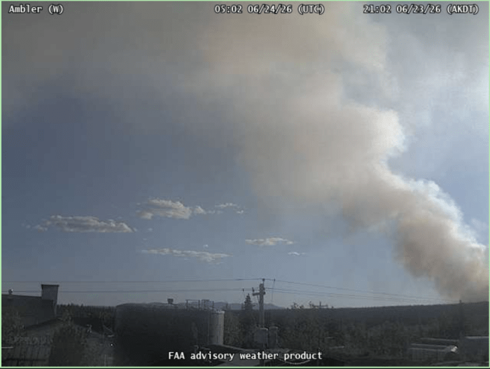 A smoke column is in the distance as taken from an FAA weather camera set up in Ambler.