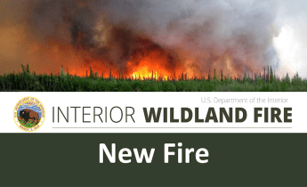 U.S. Wildland Fire Service graphic for a new fire featuring a photo of a forest fire.