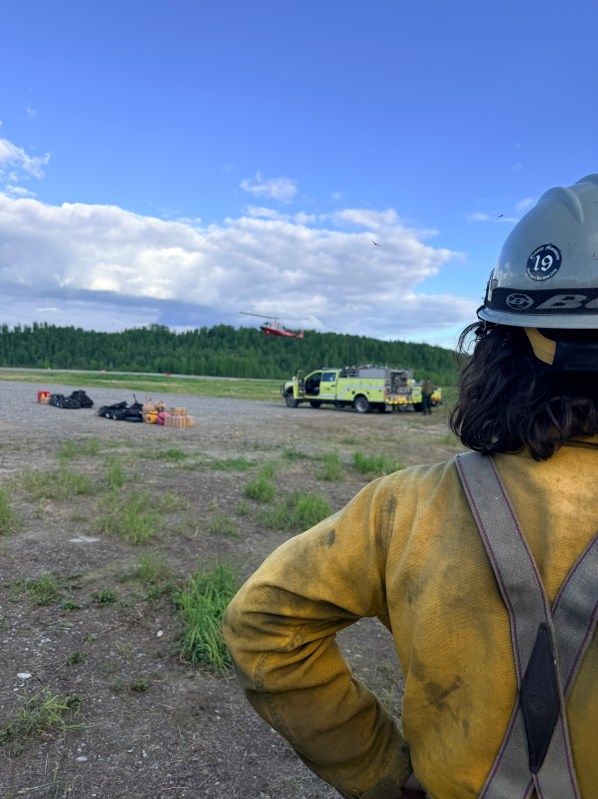 Pioneer Peak Hotshot Crewmember watches helicopter take flight. 