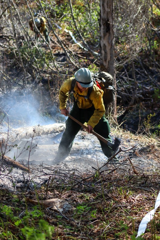 Member of Pioneer Peak Interagency Hot Shot Crew works to strengthen containment lines with pulaski on Mastadon Fire (#131).