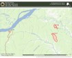 A wildland fire location map titled "Ruby Area Fires," that shows two fire perimeters (outlined in red, shaded pink) east of the village of Ruby, Alaska, which sits on the south bank of the Yukon River. The Yukon River flows across the upper-left portion of the map, joined by Bootlegger Slough and the Melozitna River, with Ruby's local road network shown in orange. To the east, two fires are marked with red outlines and burning symbols: 313-Big (241.5 acres) — the smaller, northern fire, an elongated shape located near Big Creek and 315-Cecil (724 acres) — the larger, southern fire, a longer north-south oriented shape located near Little Boulder Creek.