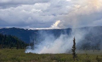 Smoke rises from a wildland fire.