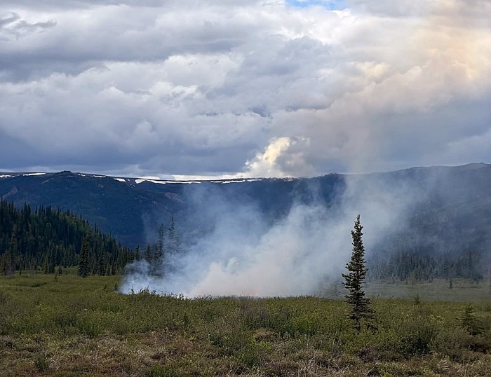 Smoke rises from a wildland fire.