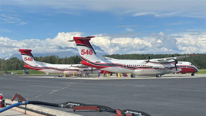 Photo of two retardant tankers on tarmac getting filled with retardant.