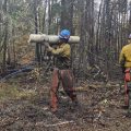 Firefighter Vincent Wade carries a log