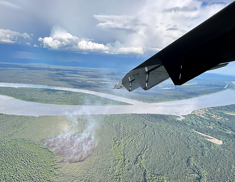 Smoke wisps up from a burned area